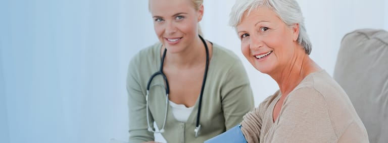 A smiling healthcare professional wearing a stethoscope