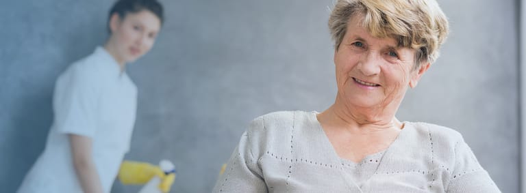 A carer assisting a client with daily activities at home