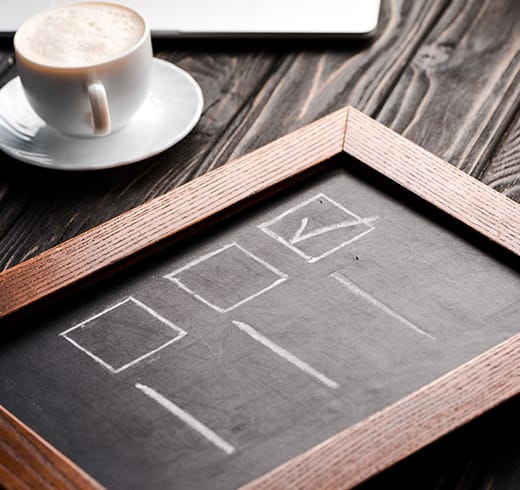 A planning notebook and coffee cup on a desk during an assessment